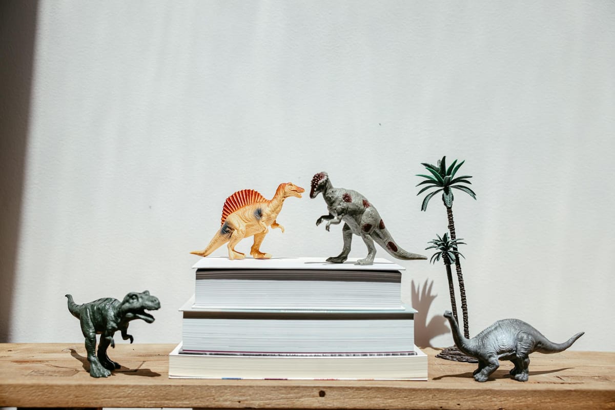 plastic dinosaur toys on wooden table